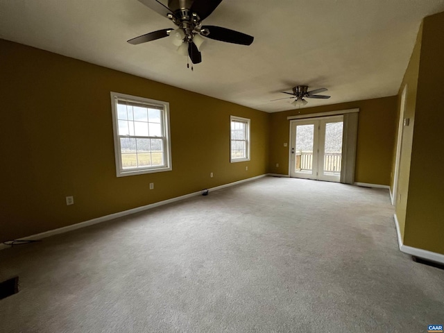 unfurnished room featuring french doors, carpet flooring, ceiling fan, and baseboards