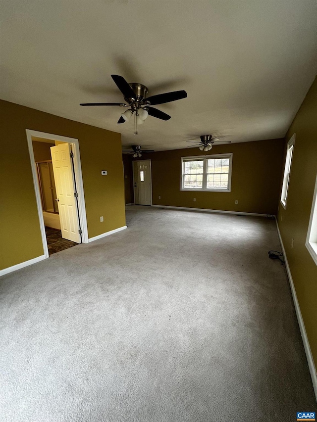 carpeted spare room with baseboards