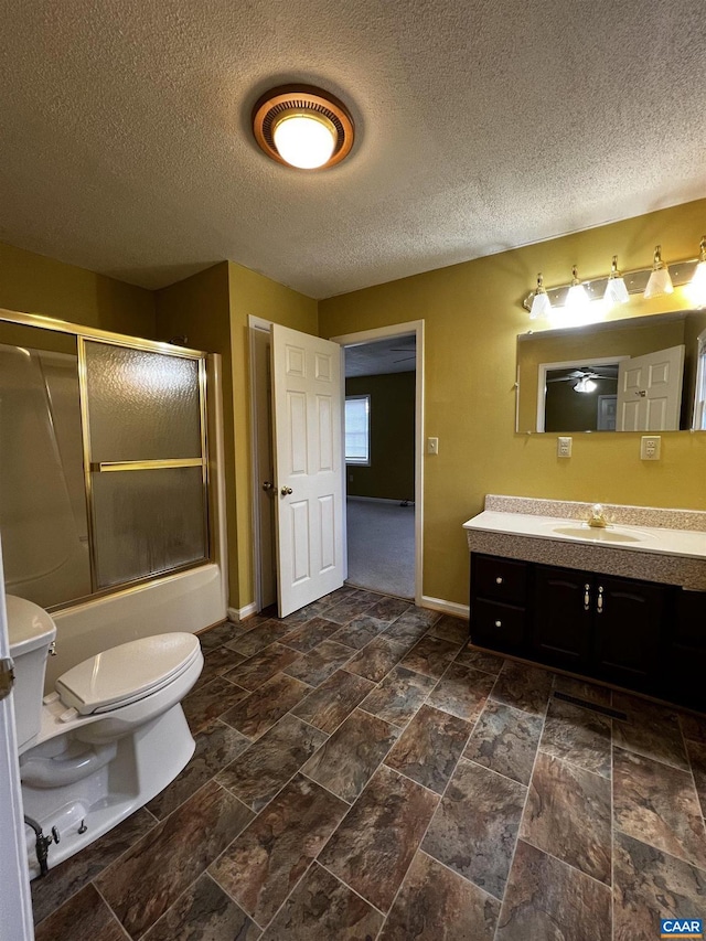 full bathroom featuring enclosed tub / shower combo, vanity, toilet, and baseboards