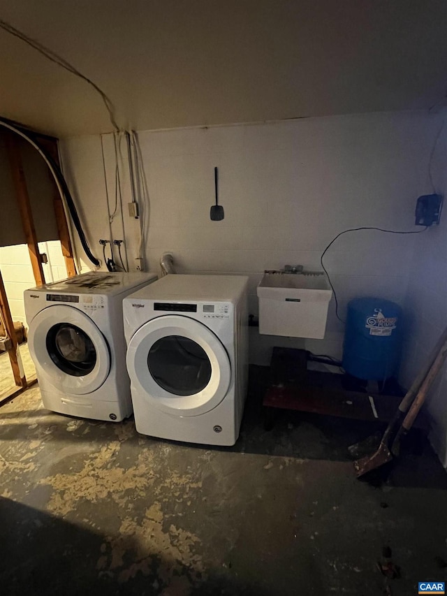 washroom with a sink, laundry area, and washer and dryer