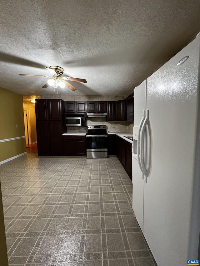 kitchen with light countertops, appliances with stainless steel finishes, ceiling fan, a sink, and under cabinet range hood