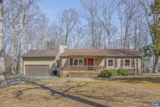 ranch-style home featuring aphalt driveway, a chimney, a porch, an attached garage, and a front lawn