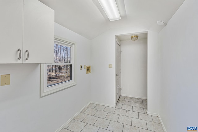 interior space featuring vaulted ceiling, light tile patterned floors, and baseboards