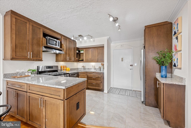 kitchen featuring brown cabinetry, appliances with stainless steel finishes, a peninsula, open shelves, and a sink