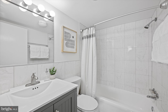 full bath with tile walls, vanity, toilet, and shower / tub combo with curtain