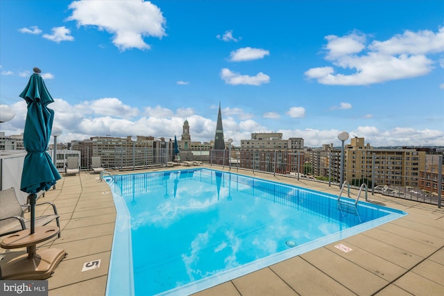 view of swimming pool with a city view