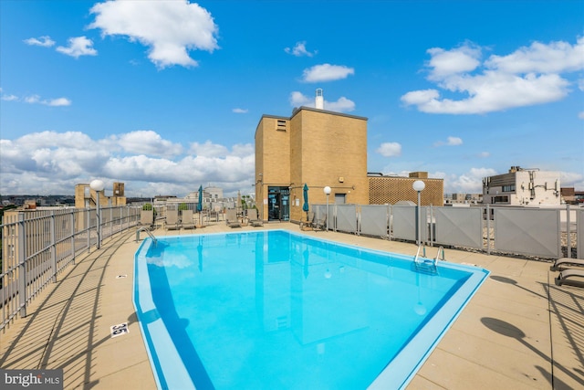 pool featuring a patio area and fence