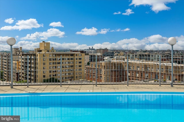 view of pool with a view of city