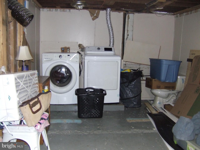 clothes washing area with laundry area and washer and clothes dryer