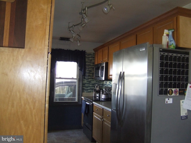 kitchen featuring appliances with stainless steel finishes, brown cabinetry, and decorative backsplash