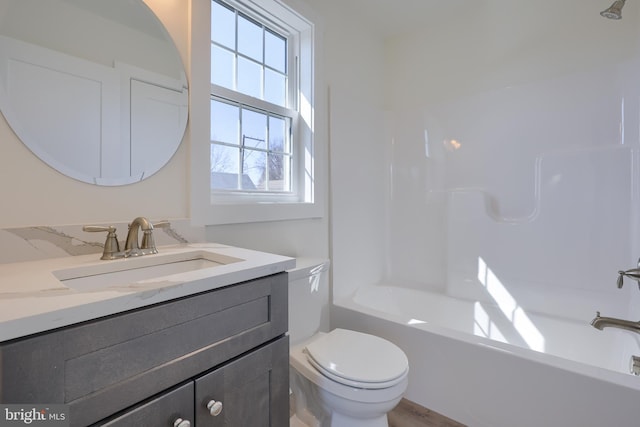 bathroom featuring shower / tub combination, vanity, and toilet