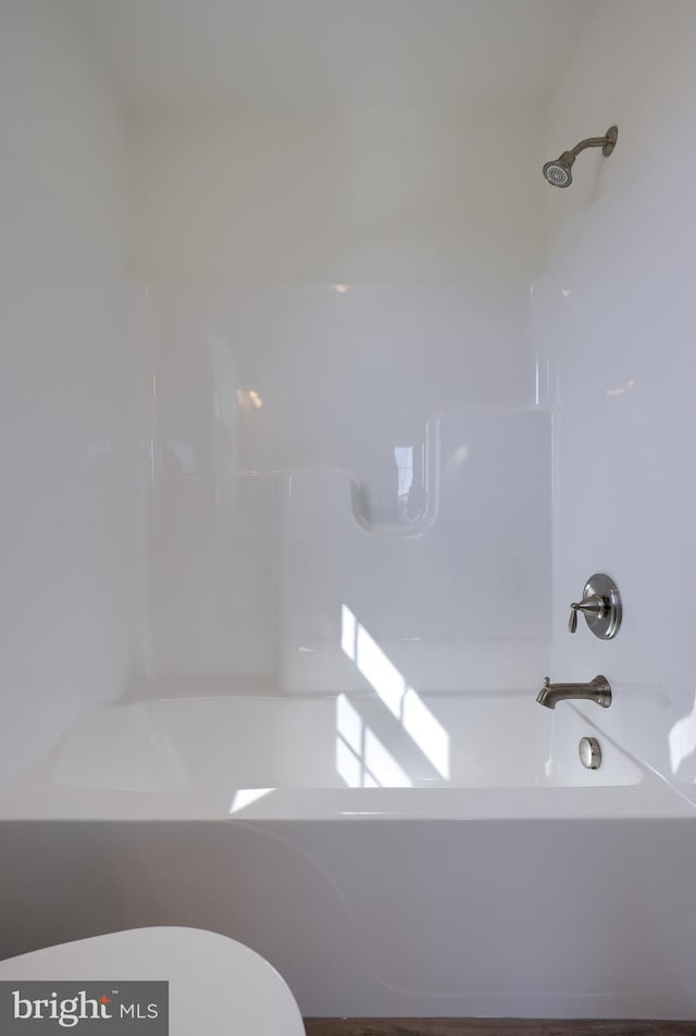 full bathroom featuring shower / bathing tub combination and toilet