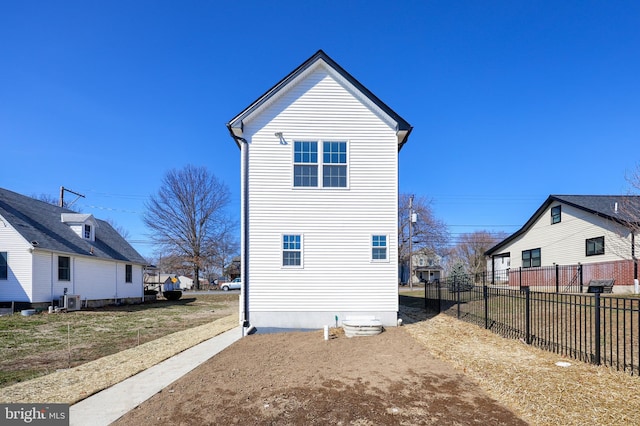 view of home's exterior featuring fence and central AC unit