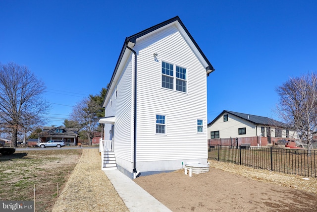 view of home's exterior with fence