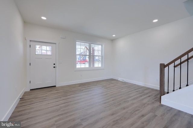 foyer entrance featuring recessed lighting, wood finished floors, baseboards, and stairs