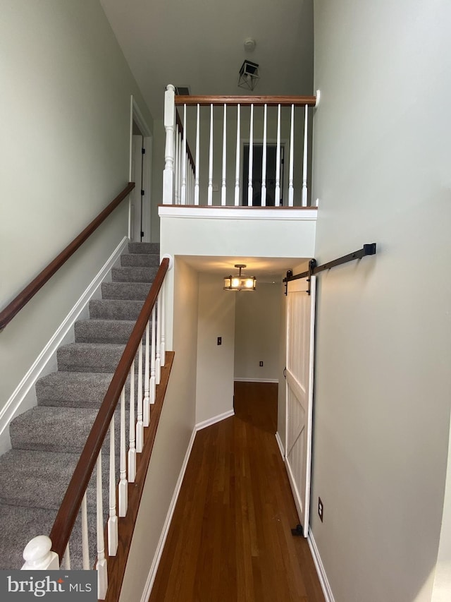 stairway with baseboards and wood finished floors