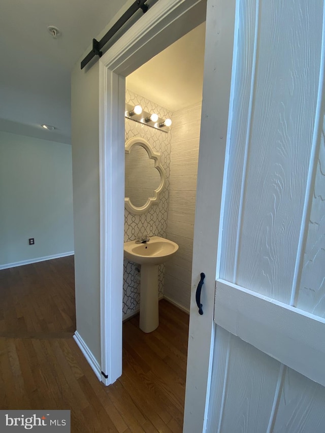 bathroom featuring wood finished floors and baseboards