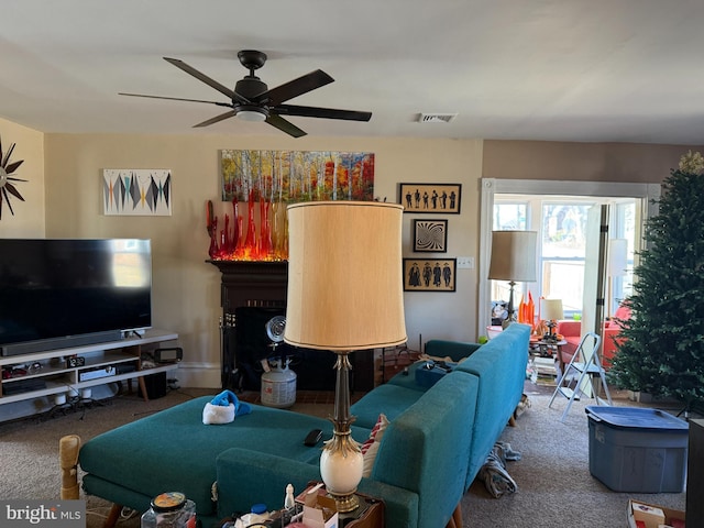 living room featuring visible vents, carpet, and ceiling fan