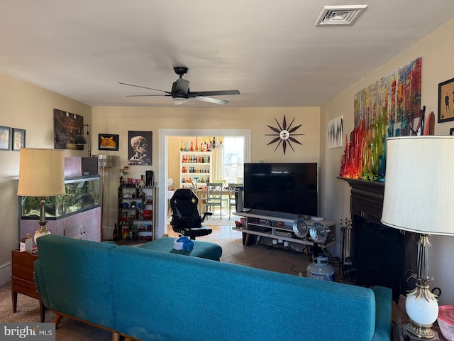 living room with visible vents and ceiling fan