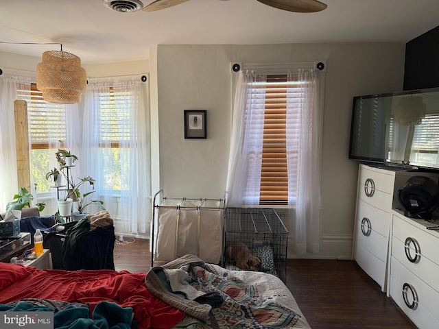 bedroom featuring wood finished floors and visible vents