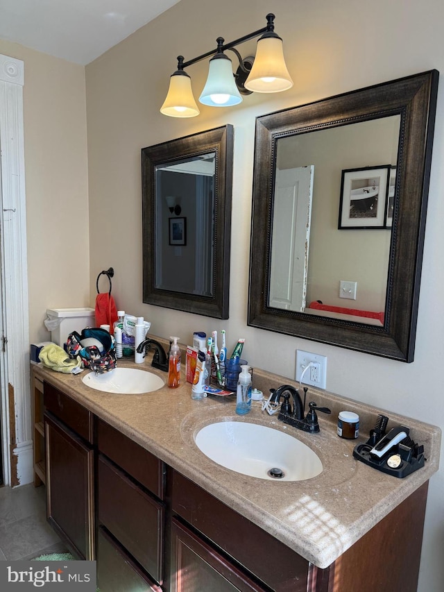 bathroom featuring double vanity, tile patterned floors, and a sink