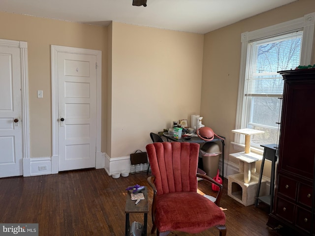 sitting room with baseboards and wood finished floors