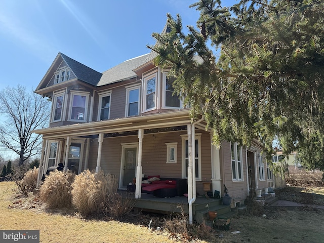 view of front of property with a porch and a shingled roof