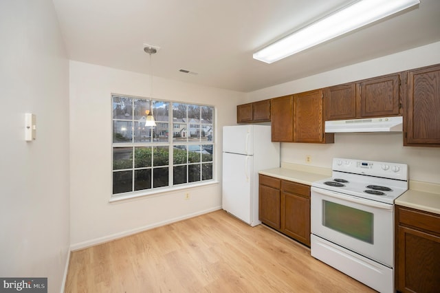 kitchen featuring light countertops, visible vents, light wood-style flooring, white appliances, and under cabinet range hood