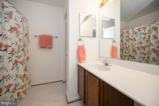 full bath featuring a shower with shower curtain, vaulted ceiling, vanity, tile patterned flooring, and baseboards