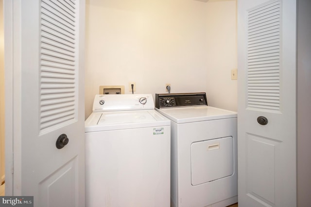 clothes washing area with laundry area and washing machine and clothes dryer