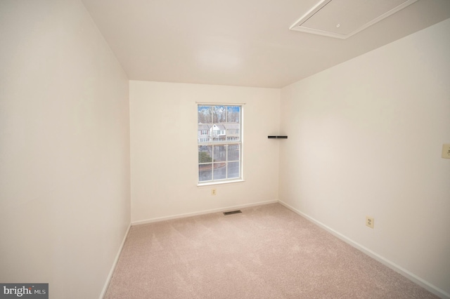 empty room featuring carpet, visible vents, and baseboards