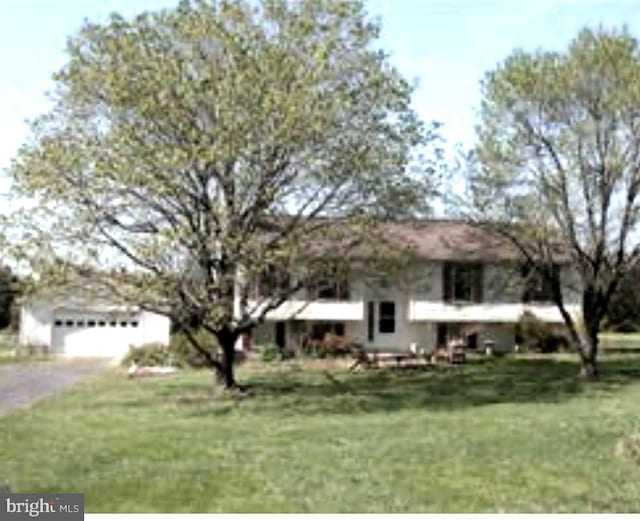 raised ranch with a garage and a front yard