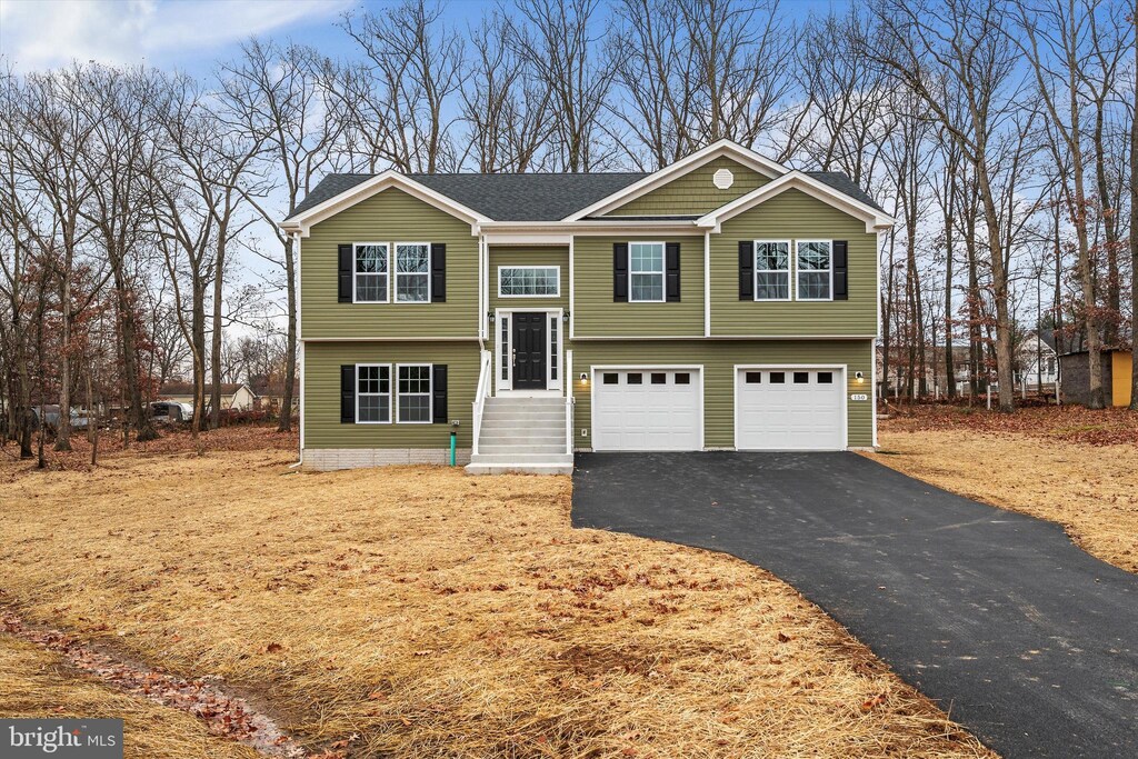 bi-level home featuring driveway and a garage