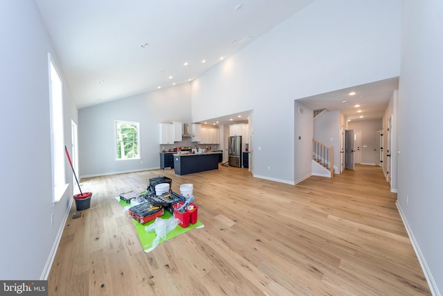 103 Matte Ln, Havre De Grace, MD 21078 - unfurnished living room featuring stairs, high vaulted ceiling, light wood finished floors, baseboards, and recessed lighting