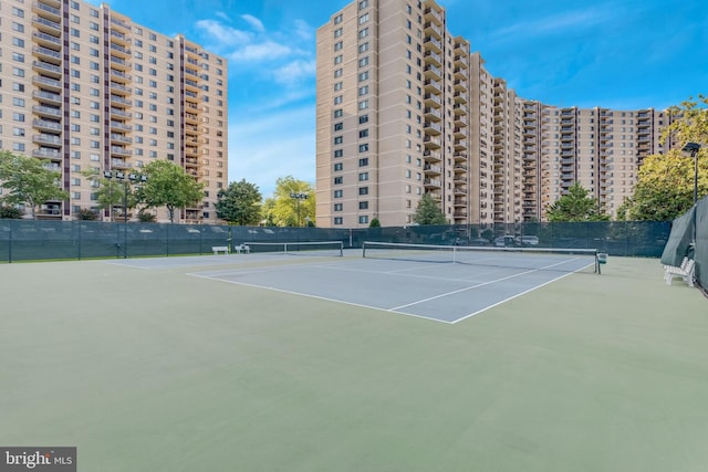 view of tennis court featuring fence