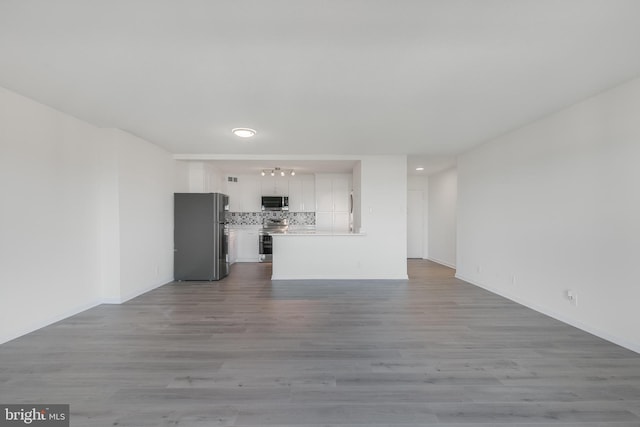 unfurnished living room with wood finished floors