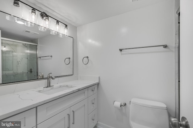 bathroom with a stall shower, visible vents, vanity, and toilet