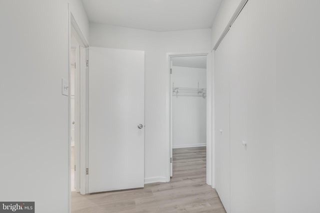 hallway with light wood-style floors