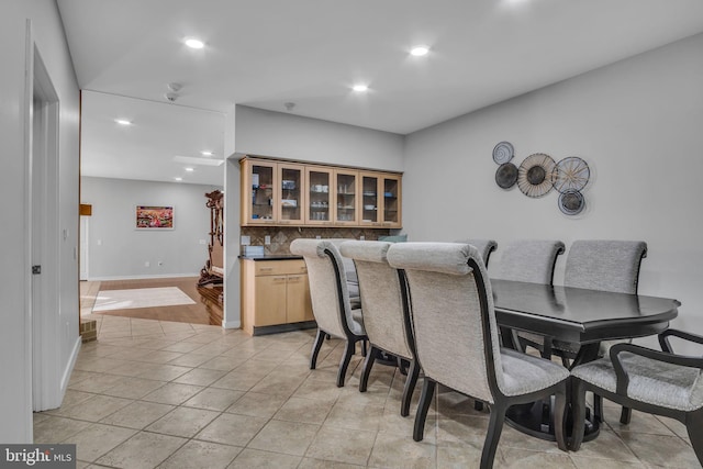 dining room with recessed lighting, baseboards, and light tile patterned flooring