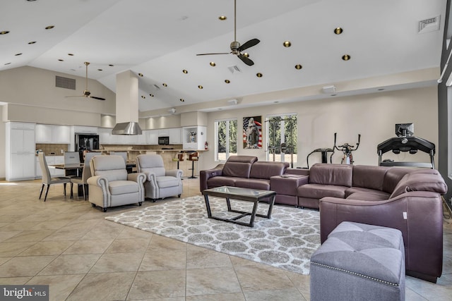 living area with a ceiling fan, visible vents, high vaulted ceiling, and light tile patterned flooring