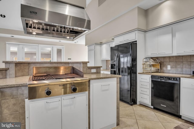 kitchen featuring decorative backsplash, white cabinets, wall chimney range hood, and black appliances