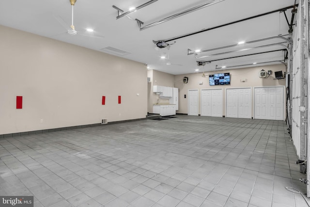 garage featuring baseboards and a garage door opener