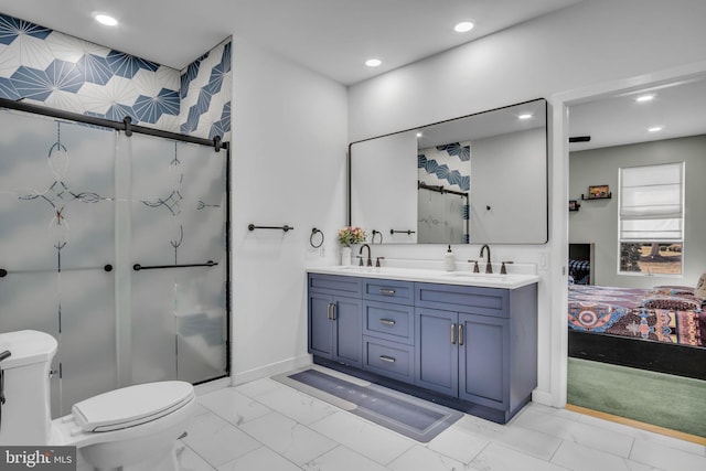 ensuite bathroom with marble finish floor, a sink, ensuite bath, and toilet