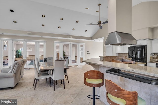 dining space featuring high vaulted ceiling, french doors, light tile patterned flooring, and ceiling fan