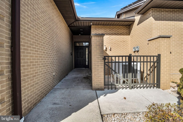 property entrance featuring brick siding