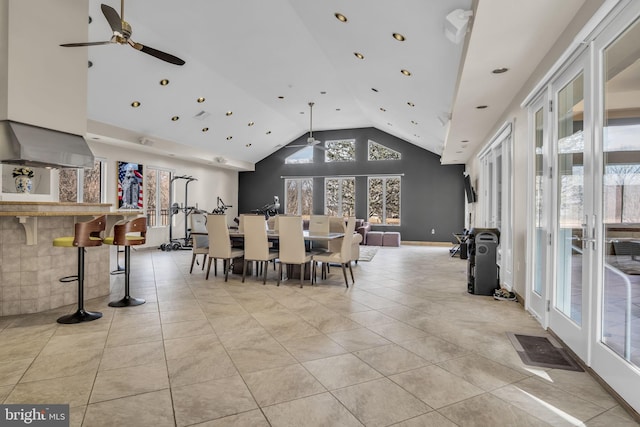 dining space featuring a ceiling fan, french doors, high vaulted ceiling, and light tile patterned floors