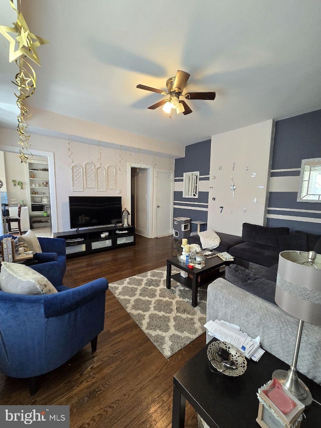 living area featuring ceiling fan and wood finished floors