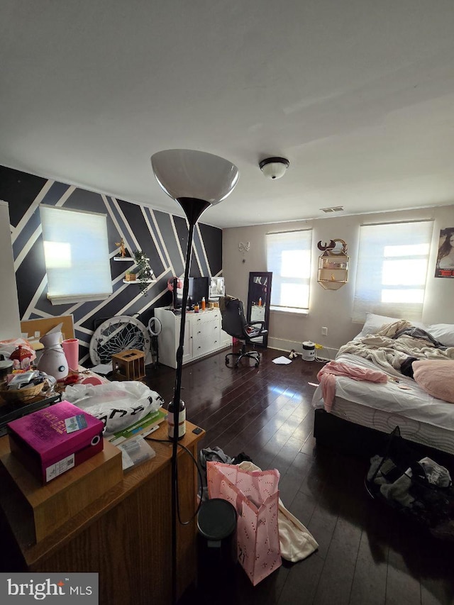 bedroom featuring dark wood-type flooring and baseboards