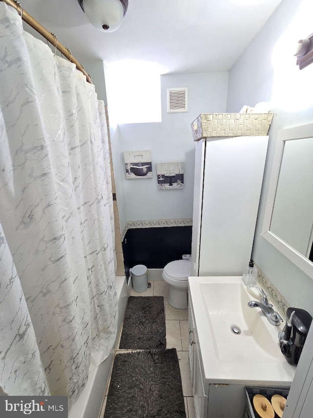 bathroom with toilet, vanity, visible vents, tile patterned floors, and shower / bath combo with shower curtain