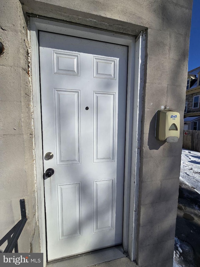 doorway to property featuring stucco siding